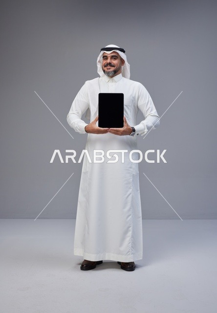 Saudi Man Holding Tablet Blank Screen in Studio
