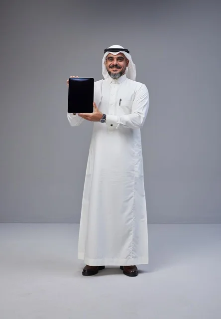 Saudi Man in Traditional Thobe Holding Tablet Mockup