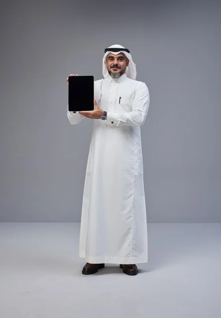 Saudi Man Holding Tablet with Blank Screen in Studio