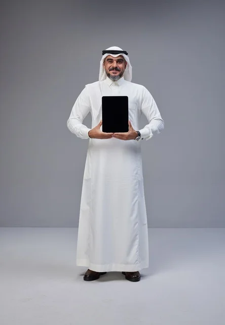 Saudi Man in Traditional Thobe Holding Blank Tablet