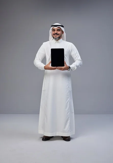 Saudi Man in Traditional Dress Holding Tablet Mockup