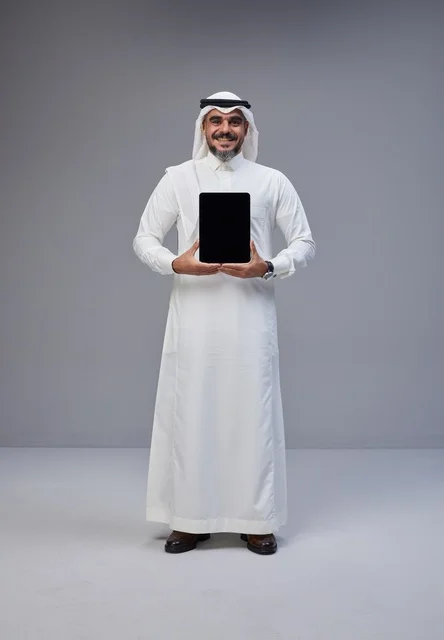 Saudi Man Holding Tablet with Blank Screen in Studio