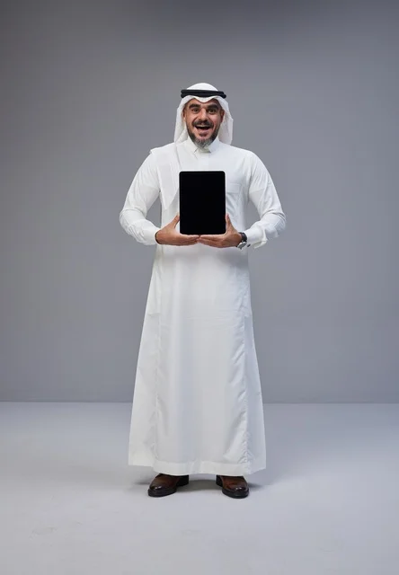 Saudi Man in Traditional Thobe Holding Blank Tablet