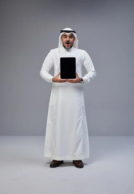 Surprised Saudi Man Holding Tablet with Blank Screen