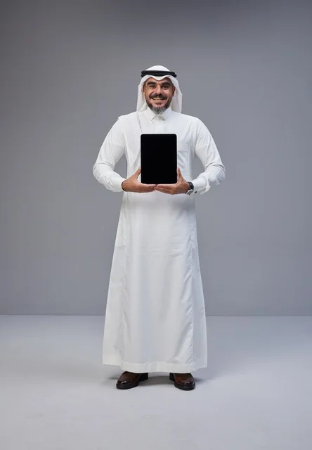 Saudi Man in Thobe Holding Tablet with Blank Screen
