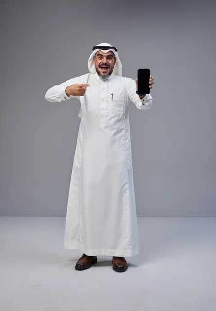 Saudi Man in Thobe Pointing at Smartphone Screen