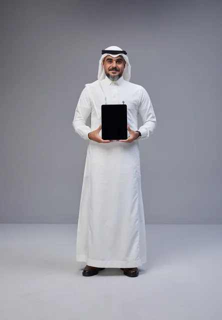 Saudi Man in Traditional Thobe Holding Blank Tablet
