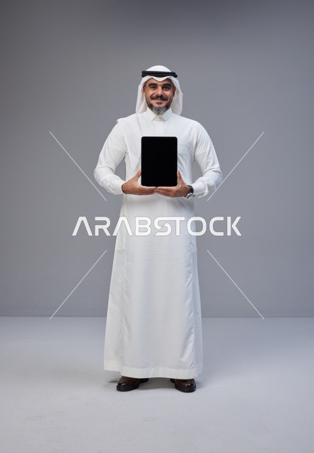 Saudi Man in Traditional Thobe Holding Tablet Mockup