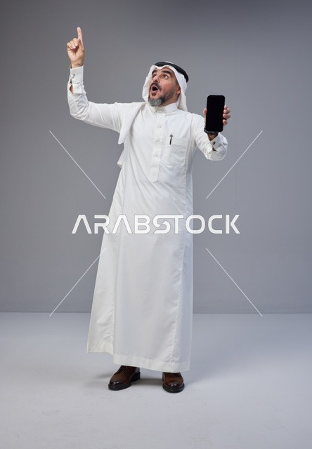Saudi Man Holding Blank Smartphone Screen Pointing Up