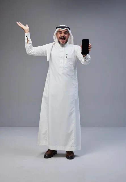 Saudi Man Holding Blank Smartphone Screen on Grey