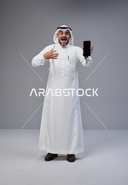 Excited Saudi Man Holding Blank Smartphone Screen