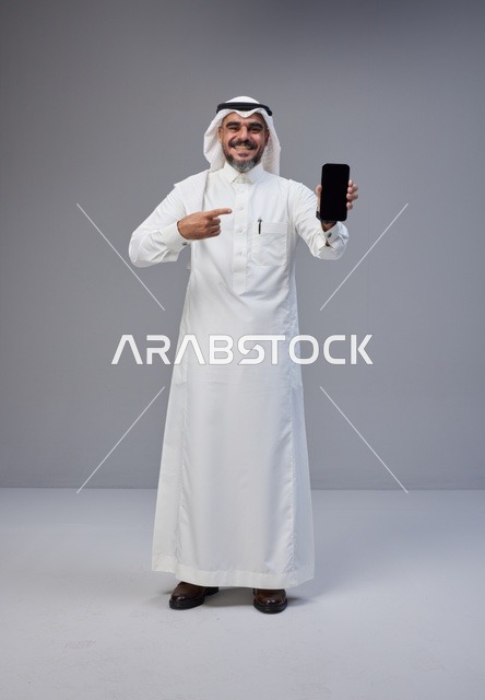 Saudi Man Pointing at Blank Smartphone Screen
