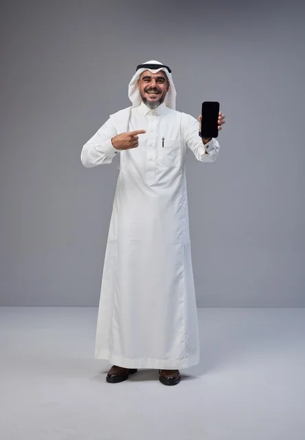 Saudi Man in Traditional Dress Holding Blank Smartphone