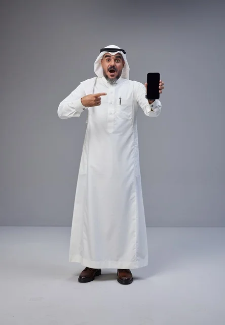 Saudi Man Holding Blank Smartphone with Shocked Face