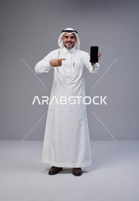 Saudi Man Holding Smartphone with Blank Screen