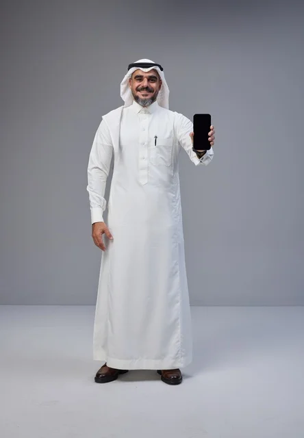 Saudi Man in Thobe Holding Blank Smartphone Screen