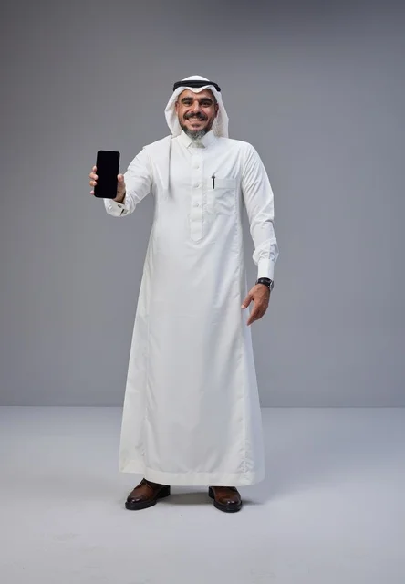 Saudi Man in Traditional Dress Holding Blank Smartphone