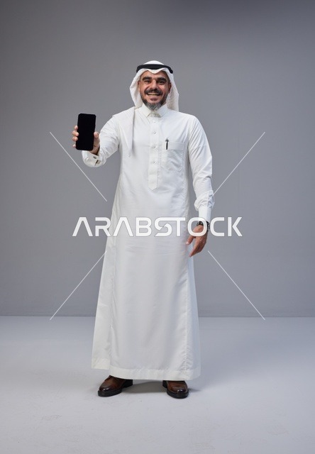 Saudi Man Holding Smartphone with Blank Screen