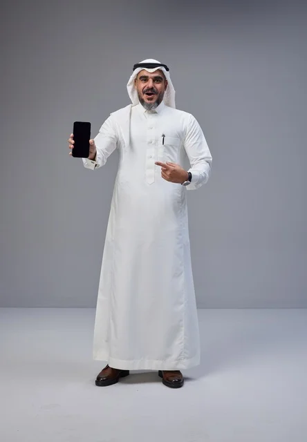 Saudi Man in Traditional Thobe Holding Smartphone Mockup