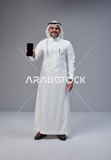 Saudi Man Holding Smartphone with Blank Screen