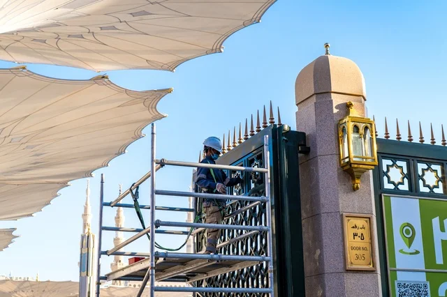 Worker Maintaining Prophet's Mosque Gate in Medina
