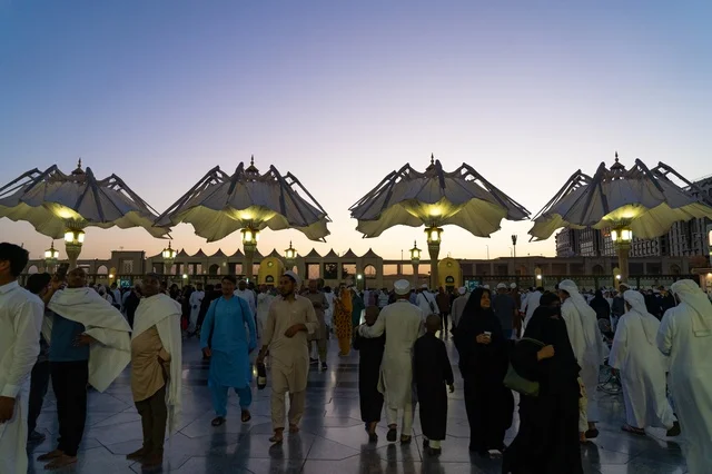 Prophet's Mosque Medina Pilgrims and Umbrellas at Sunset