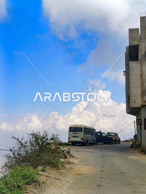Minibus on Jazan Mountain Road with Clouds