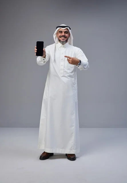 Saudi Man in Traditional Thobe Holding Blank Smartphone