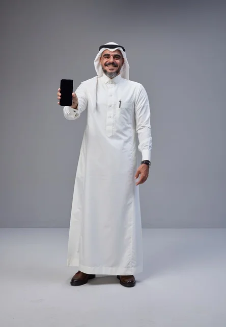 Saudi Man in Traditional Thobe Holding Blank Smartphone