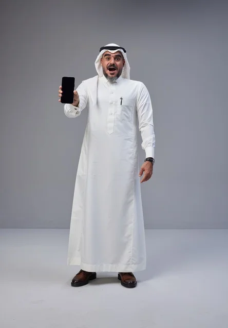 Saudi Man in Thobe Holding Blank Smartphone Screen