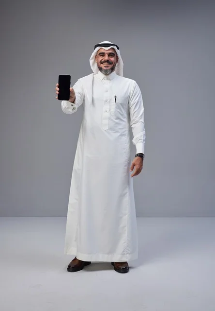 Saudi Man in Traditional Thobe Holding Blank Smartphone