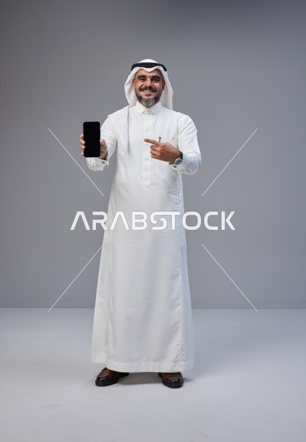 Saudi Man Holding Smartphone with Blank Screen