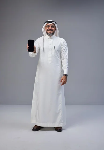 Saudi Man in Traditional Thobe Holding Blank Smartphone Screen