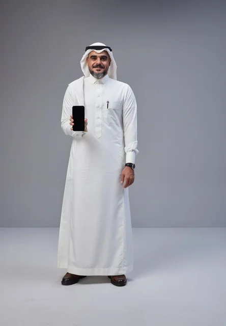 Saudi Man in Traditional Thobe Holding Smartphone Mockup