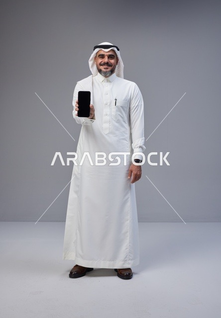 Saudi Man Holding Smartphone with Blank Screen
