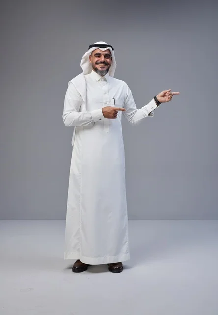 Saudi Man in Traditional Thobe Pointing in Studio