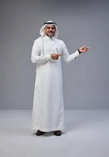 Saudi Man in Traditional Thobe Pointing in Studio