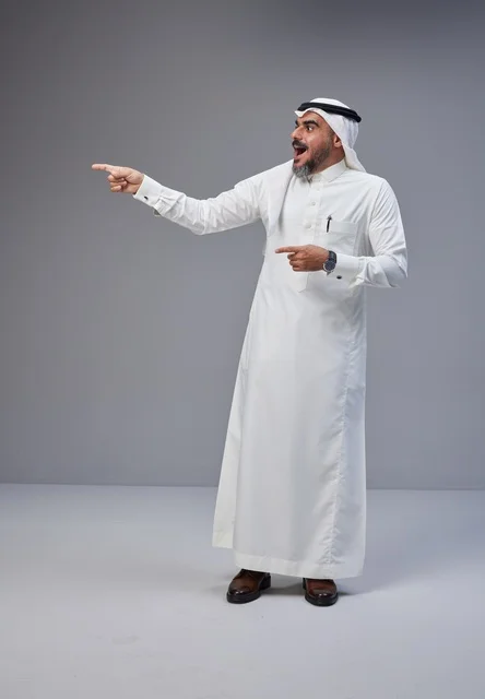 Surprised Saudi Man in Traditional Thobe Pointing Sideways