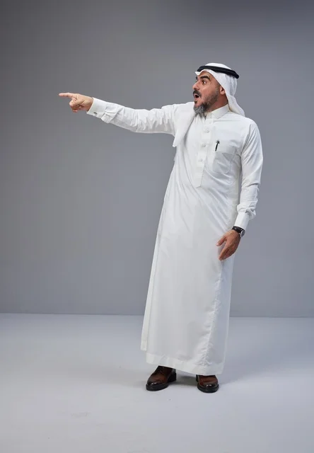 Saudi Man in Traditional Dress Pointing with Shocked Expression