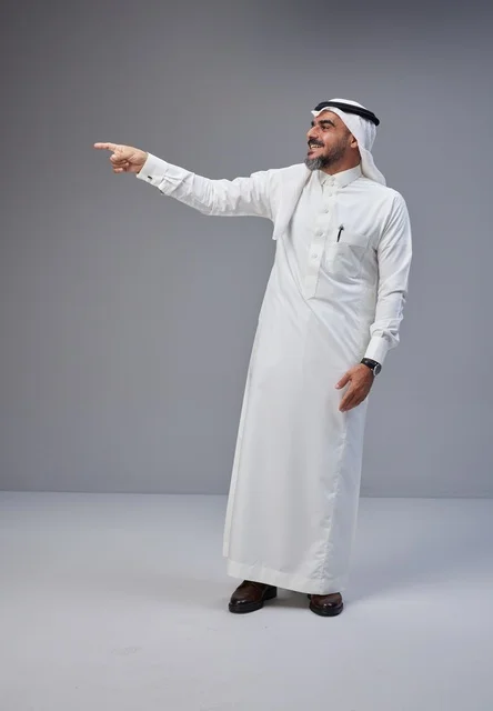 Saudi Man in Traditional Thobe Pointing in Studio
