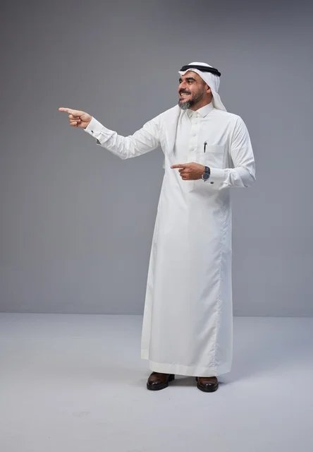Saudi Man in Traditional Dress Pointing in Studio