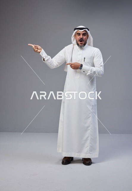 Saudi Man in Traditional Thobe Pointing with Surprise