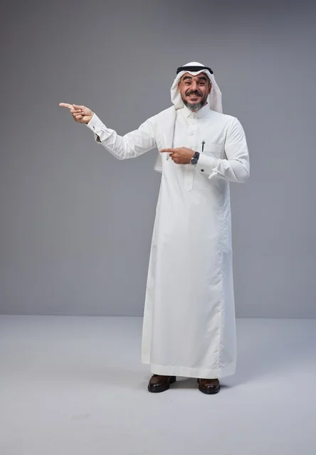 Saudi Man in Traditional Thobe Pointing Side Studio