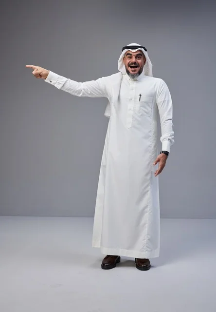 Excited Saudi Man in Traditional Thobe Pointing Side