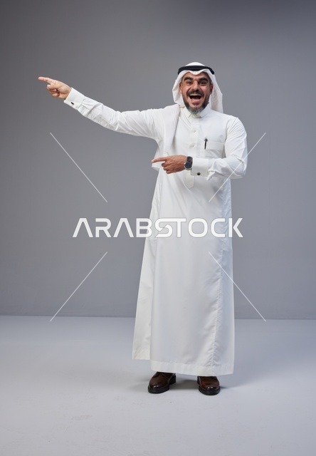 Saudi Man in Traditional Thobe Pointing in Studio Shot