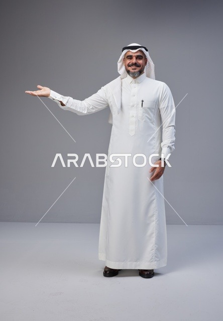 Saudi Man in Traditional Thobe Presenting Gesture