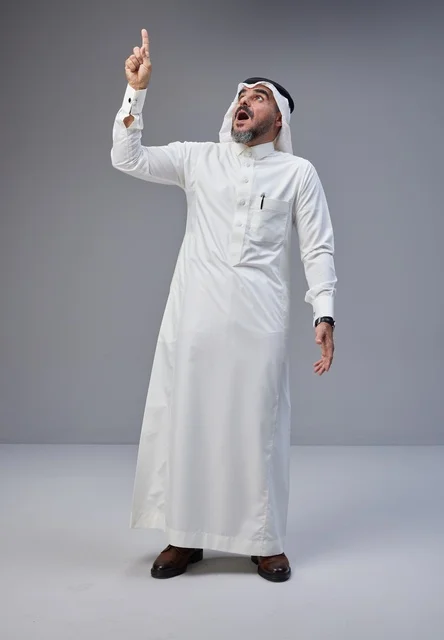 Saudi Man in Traditional Thobe Pointing Up in Surprise