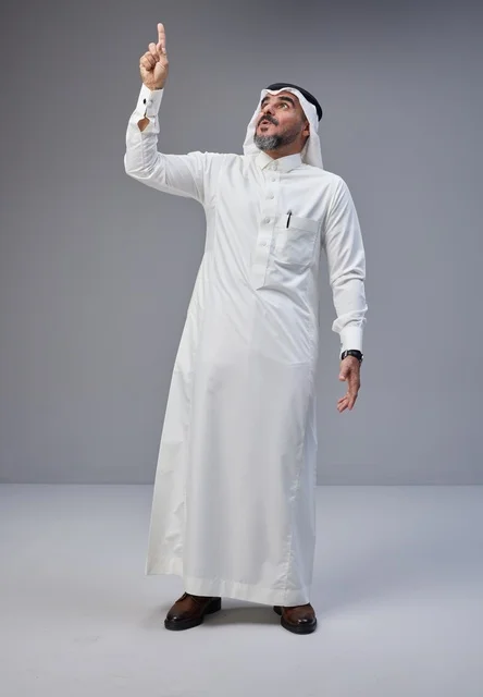 Saudi Man in Traditional Attire Pointing Upward