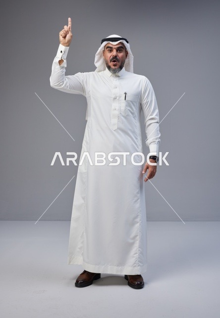 Surprised Saudi Man Pointing Up in Studio