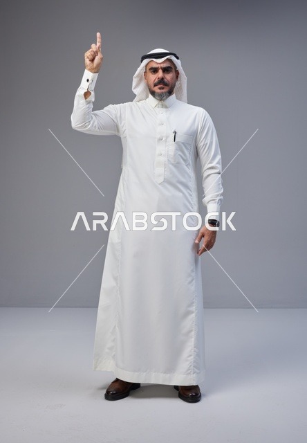 Saudi Man in Traditional Thobe Pointing Upward